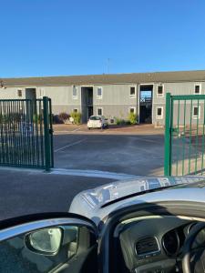 a car parked in a parking lot next to a building at hotel barbery in La Celle-sous-Gouzon
