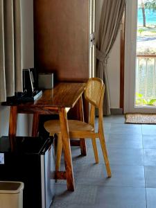 a wooden desk with a chair and a computer on it at White Beach Resort Longset in Koh Rong Island