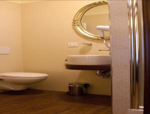 a bathroom with a toilet and a sink and a mirror at Hotel Villa Clementina in Scafati +49 photos