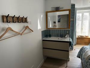 ein Badezimmer mit Waschbecken und Spiegel in der Unterkunft Ar Gwennili Chambres d'Hôtes 