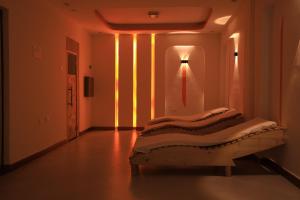 a bed in a room with a light on the wall at My Dream Apartments - 4 miles from Bole International Airport in Addis Ababa