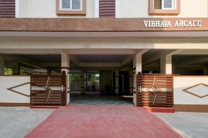 a front entrance to a building with wooden gates at Super Townhouse Oak Bachupally Medical College Formerly SV Hotels in Lingampalli