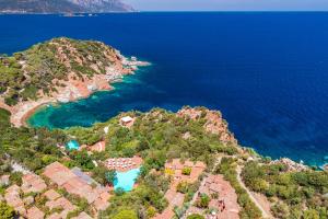 an aerial view of an island with blue water at Arbatax Park Resort - Borgo Cala Moresca by Falkensteiner in Àrbatax