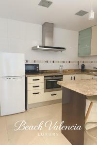 a kitchen with white appliances and a marble counter top at BEACH VALENCIA LUXURY A40-13 Apartment with terrace and sea views in Valencia