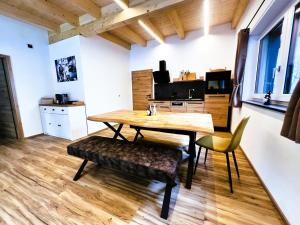a dining room with a wooden table and chairs at LechHuamat in Weissenbach am Lech
