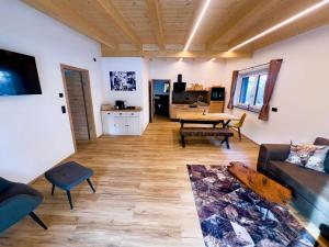 a living room with a couch and a table at LechHuamat in Weissenbach am Lech +18 photos