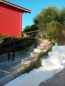 a path to a red building with a fence at Chalet d'Art in Saint-Georges