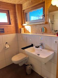 a bathroom with a white sink and a toilet at Wald ist Zukunft in Bernbeuren +86 photos