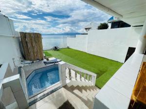 a swimming pool on the side of a house at Oceanfront Scuba Villa in Moalboal