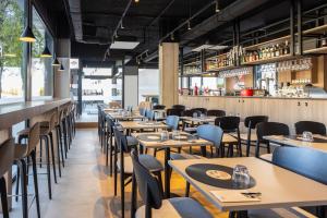 a row of tables and chairs in a restaurant at ibis Madrid Norte Las Tablas in Madrid