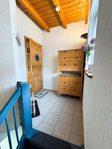 a room with a staircase and a wooden ceiling at Ferienwohnung zum Kirchturmblick in Dettelbach +3 photos