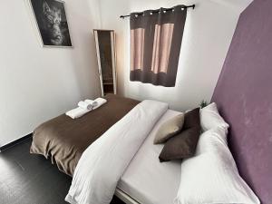 a bedroom with two beds and a window at Zaliv Apartments in Tivat
