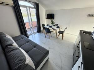 a living room with a couch and a table at Apartmani Zaliv in Tivat