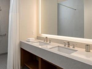 a bathroom with two sinks and a large mirror at Marriott Vacation Club, Waikīkī- 1 BEDROOM in Honolulu
