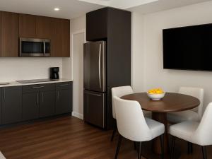 a kitchen with a small table and a refrigerator at Marriott Vacation Club, Waikīkī- 1 BEDROOM in Honolulu