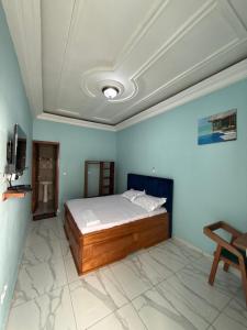 Una cama o camas en una habitación de Résidence akiba home plus