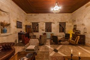 a large living room with furniture and a chandelier at Yunak Evleri Cappadocia in Urgup