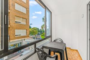 a balcony with a chair and a table and a window at Unique hotel apartment 1-2 in Torrevieja +12 photos