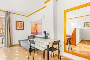 a dining room with a table and chairs and a mirror at Unique hotel apartment 1-2 in Torrevieja