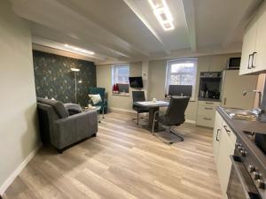 Ferienwohnung im Gulfhof, 65269 في Moormerland: غرفة معيشة مع أريكة وطاولة وكراسي