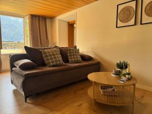 a living room with a couch and a table at River-2 with Iconic Jungfraujoch View in Interlaken