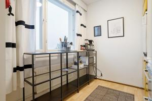 a room with a book shelf and a window at Cozy Studio, Free Parking By Lapland Host in Rovaniemi