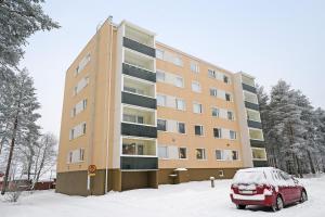 a car parked in front of a building in the snow at Cozy Studio, Free Parking By Lapland Host in Rovaniemi