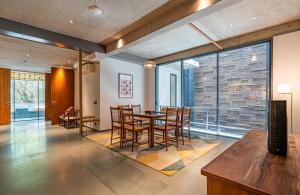 a dining room with a table and chairs at Gulmohar527 3BHK Service Apartment Defence Colony in Jāmb