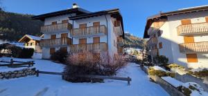 a building with snow in front of it at Casa Vaiolet in Pozza di Fassa