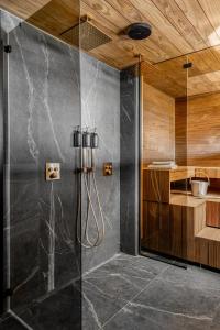 a shower with a glass door in a bathroom at Casa Pickala - The Luxury of life in Hovgård +73 photos