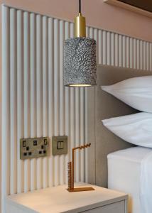 a lamp on a table next to two beds at Rooms at 32 in Sligo
