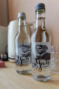 two bottles of water sitting on a table at Rooms at 32 in Sligo