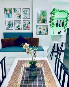 a living room with a vase with flowers on a table at Naga City River View 2BR UB Apartment in Naga