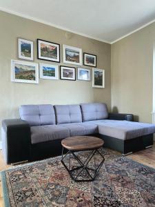 a living room with a couch and a table at La Quiete del Mattino in Torre Pellice