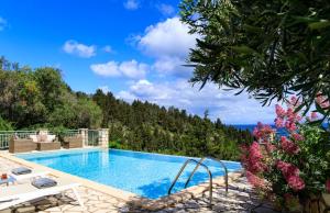 a swimming pool with a view of the ocean at Thanelli in Georgoutsátika