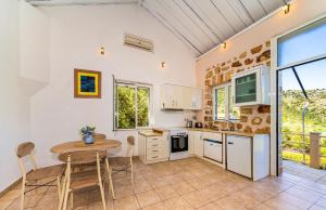 a kitchen with a table and a table and chairs at Amalthia Cottage in Vathi, Ithaka