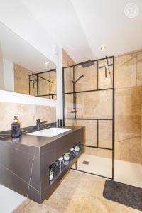 a bathroom with a sink and a shower at Romy in Aillon-le-Jeune