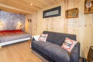 a living room with a couch and a bed at Romy in Aillon-le-Jeune