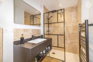 a bathroom with a sink and a shower at Romy in Aillon-le-Jeune