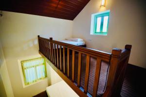 a room with a staircase with a bed and a window at Chathra Rajgama in Ratgama Hegoda