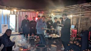 a group of people standing in a room with food at Asahi Seaside Cottage - Vacation STAY 42134v in Asahi
