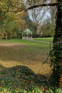 a gazebo in a park with leaves on the grass at Aston Hall Hotel, BW Signature Collection in Sheffield
