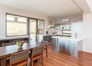 a kitchen with a large wooden table and chairs at Villa Isidora in Sitia
