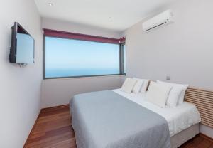 a bedroom with a large bed and a window at Villa Isidora in Sitia