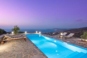 a villa with a swimming pool at night at Villa Isidora in Sitia +13 photos