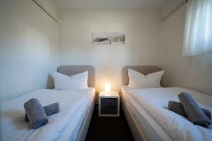 Postel nebo postele na pokoji v ubytování Haus Sonnenwinkel Bungalow 4 + 10 fotografií