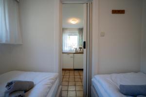 Postel nebo postele na pokoji v ubytování Haus Sonnenwinkel Bungalow 5 + 9 fotografií