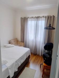 Кровать или кровати в номере Apartamento à 3min do Aeroporto