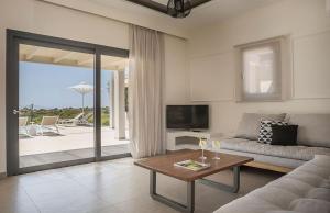 a living room with a couch and a table at Villa Anelle in Karavádhos