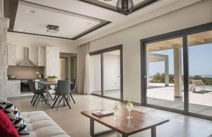 a living room with a couch and a table at Villa Anelle in Karavádhos